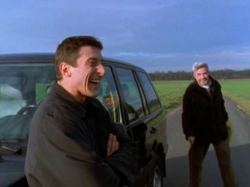 Methos and Joe laugh stranded on the side of the road