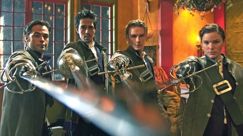 Young Blades promotional photo - four musketeers brandishing swords towards viewer